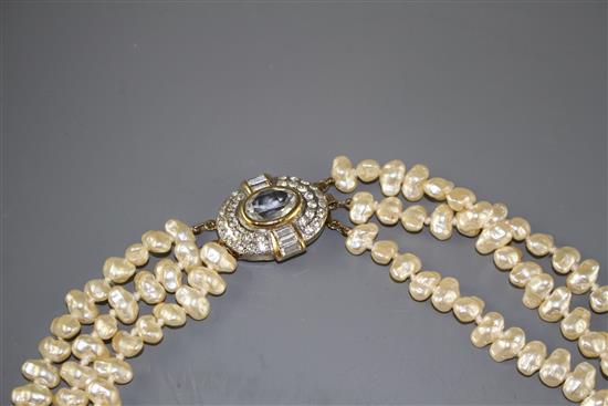 A double strand cultured baroque pearl necklace with yellow metal and garnet ? cluster clasp and one other simulated pearl necklace.